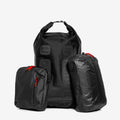 The Cancha Adventure Bundle is showcased against a plain white background, featuring three sleek black bags of varying sizes with striking red zippers. Among them is the versatile Day Bag, ideal for any outing.