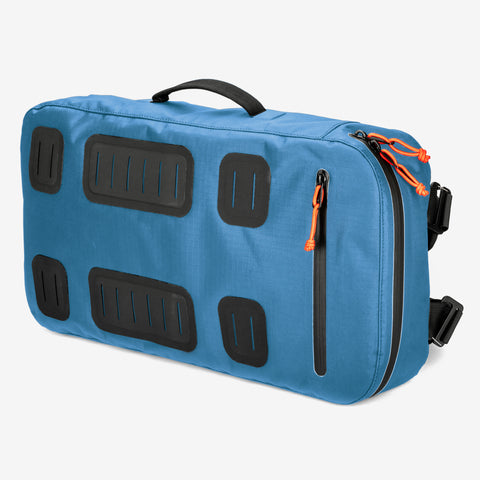 Cancha's Padel & Pickleball Bundle features a blue duffel bag with black handles, zippers, and orange zipper pulls. This versatile bag can be carried by hand or worn as a backpack and includes wet-dry compartments for organized storage.