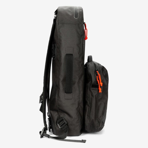 Two black backpacks from the Cancha Padel & Pickleball Bundle are displayed side by side against a white background. The larger backpack has a top handle and adjustable straps, while the smaller one features a front pocket with orange zipper pulls. Their modular accessories make them versatile, perfect for use as either a padel bag or wet-dry bag.