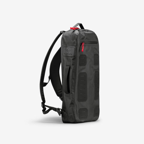 From Cancha, the Padel & Pickleball Bundle features a black tactical backpack with striking red zipper pulls and multiple strap loops for modular accessories, presented upright against a plain white background.